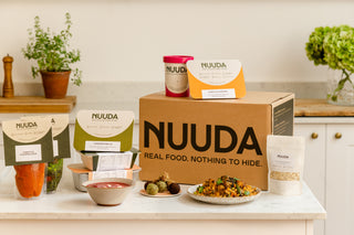 NUUDA product display with various food items and packaging on a kitchen counter.